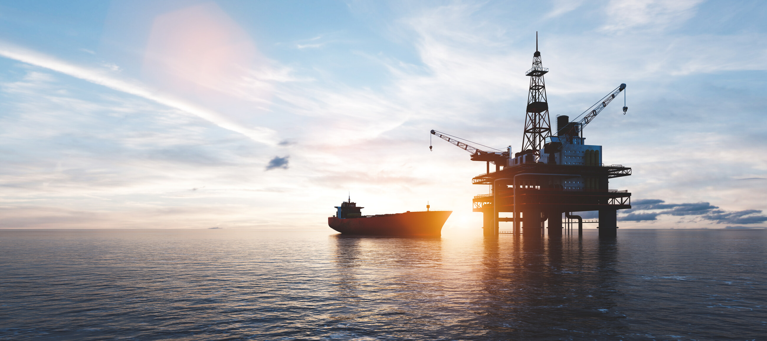 Plateforme pétrolière en mer et navire de transport au coucher du soleil