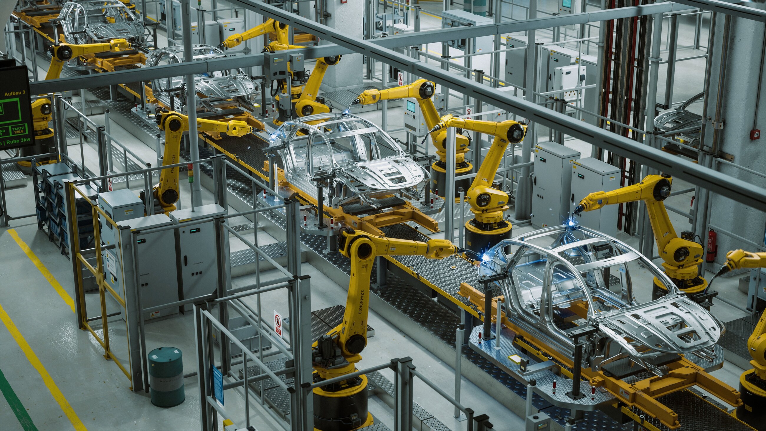 Robots jaunes assemblant des caisses de véhicules dans un atelier